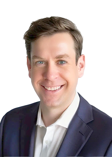 Head-and-shoulders portrait of a smiling man in a dark suit and white shirt.